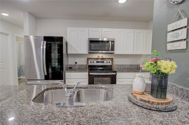 kitchen with white cabinetry, appliances with stainless steel finishes, and sink