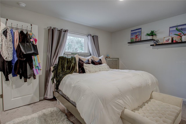 bedroom featuring light carpet