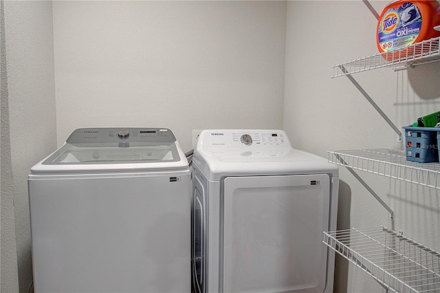 clothes washing area featuring separate washer and dryer