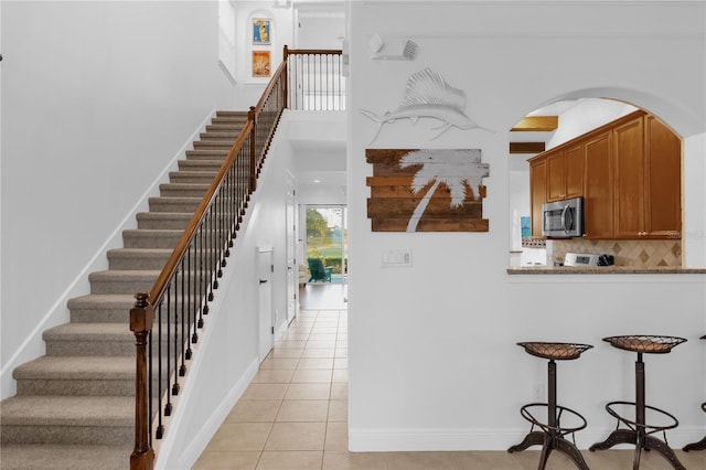 staircase featuring tile patterned floors