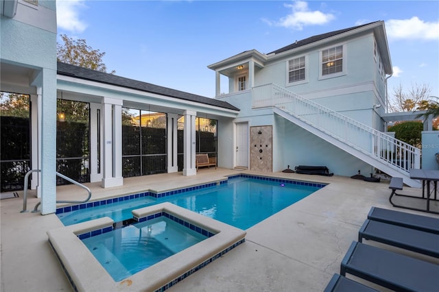 view of pool featuring an in ground hot tub and a patio