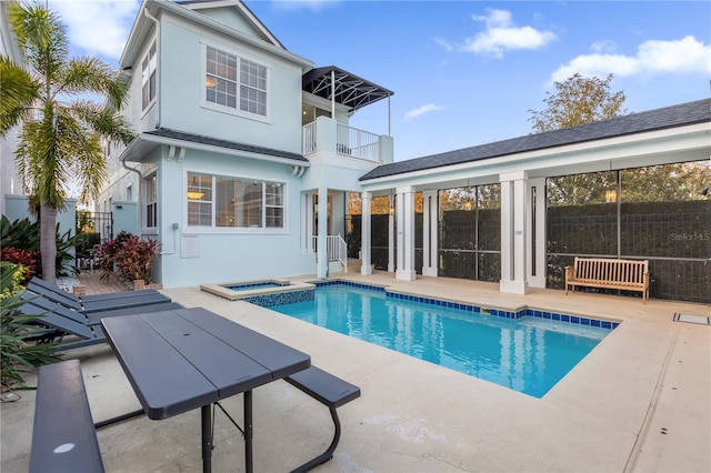 view of pool with a patio area and an in ground hot tub