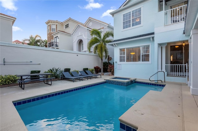 view of pool with a patio and an in ground hot tub