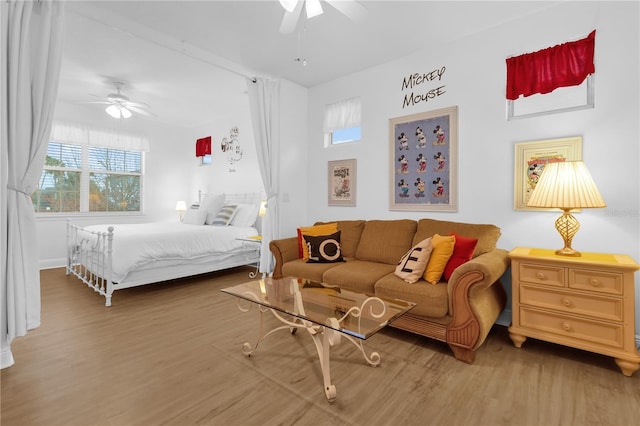 bedroom with ceiling fan and hardwood / wood-style floors