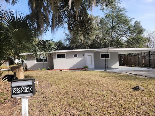 single story home featuring a carport and a front yard