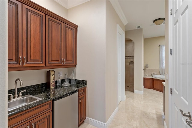 kitchen featuring dishwasher, sink, and dark stone counters