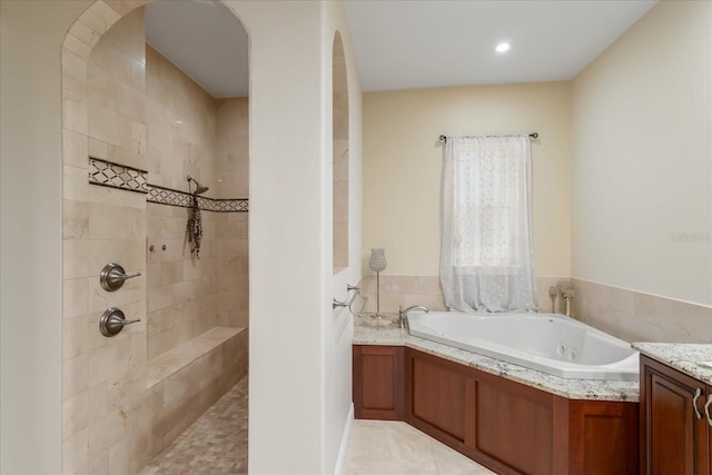 bathroom with tile patterned floors, vanity, and independent shower and bath