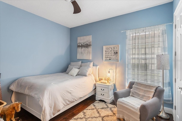 bedroom with dark wood-type flooring and ceiling fan