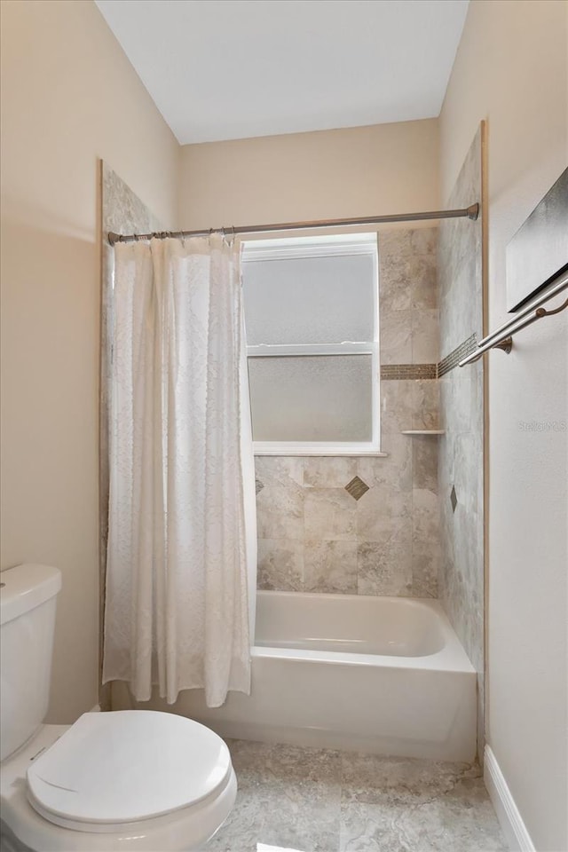 bathroom featuring toilet and shower / bathtub combination with curtain