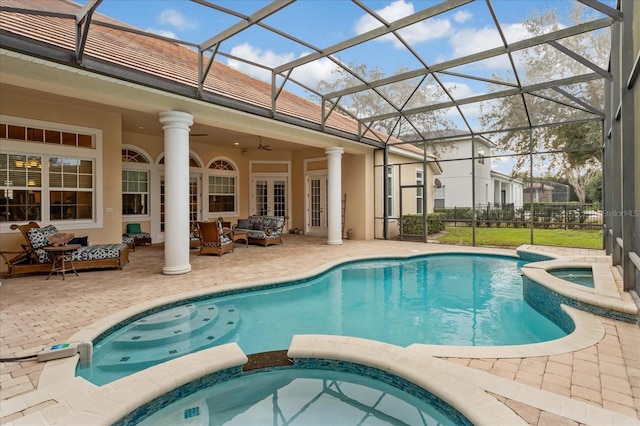 view of pool with ceiling fan, an outdoor living space, a patio area, and an in ground hot tub