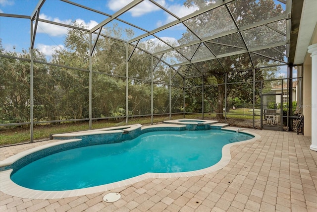 view of swimming pool with a lanai, a patio, and an in ground hot tub