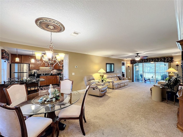 carpeted dining room with ceiling fan with notable chandelier, crown molding, and a textured ceiling