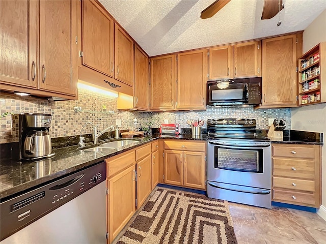 kitchen featuring decorative backsplash, sink, dark stone countertops, and stainless steel appliances