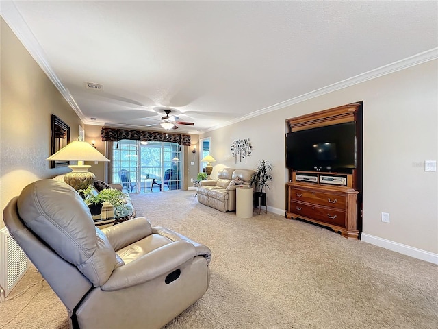 living room featuring ceiling fan, carpet, and crown molding