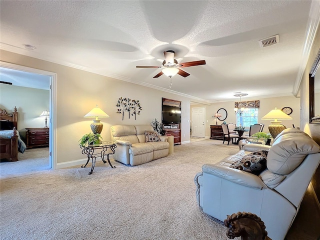 carpeted living room with ceiling fan, a textured ceiling, and ornamental molding