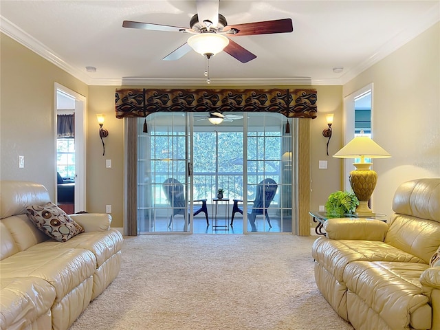 carpeted living room with ceiling fan and crown molding