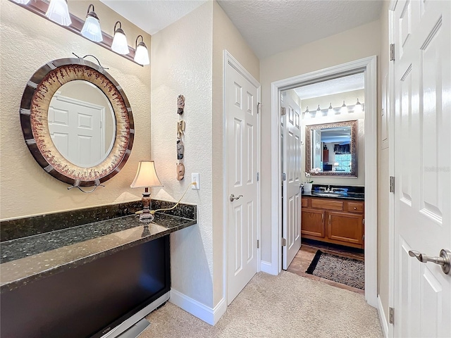 bathroom featuring a textured ceiling and vanity