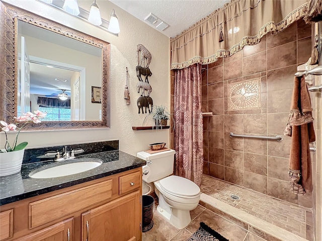 bathroom featuring toilet, tile patterned floors, walk in shower, a textured ceiling, and vanity