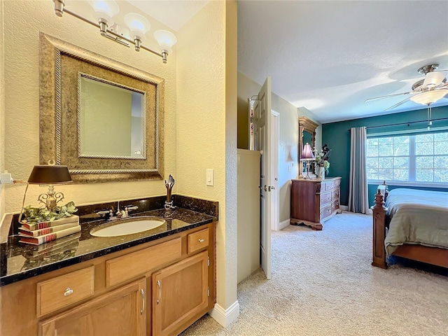 bathroom with ceiling fan and vanity