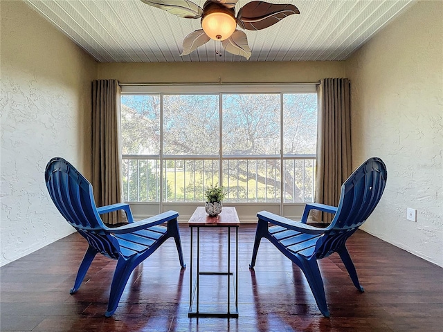 living area featuring wooden ceiling, dark hardwood / wood-style flooring, and ceiling fan