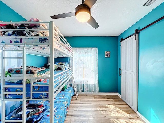 unfurnished bedroom with ceiling fan and light wood-type flooring