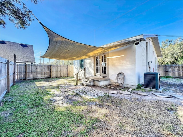 rear view of property featuring central air condition unit