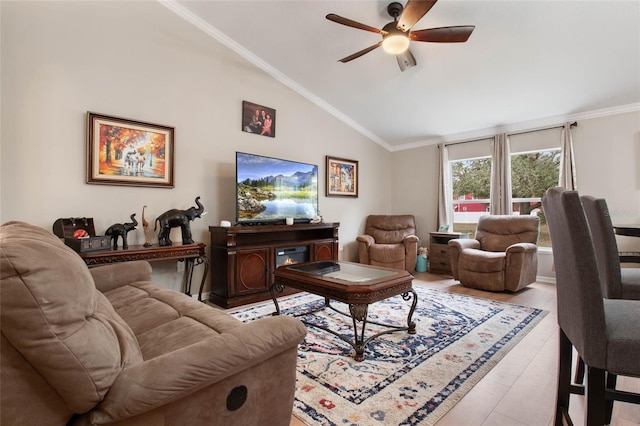 living room featuring lofted ceiling, ceiling fan, and ornamental molding