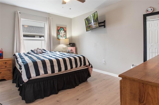 bedroom featuring ceiling fan, a closet, and light hardwood / wood-style floors