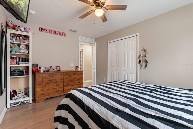 bedroom featuring ceiling fan, a closet, and light hardwood / wood-style flooring