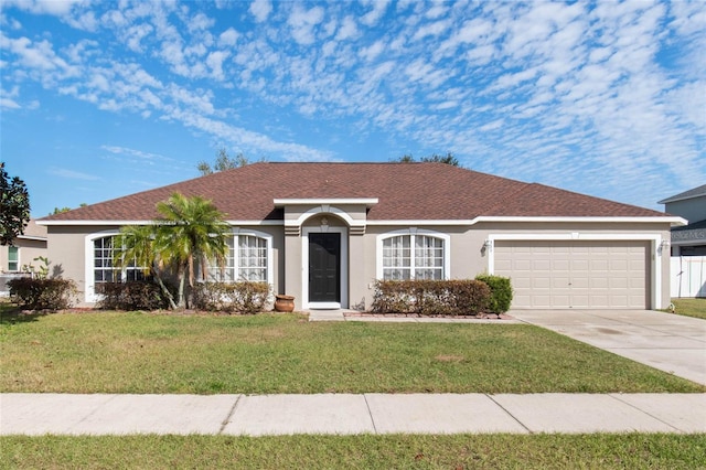 ranch-style house with a garage and a front lawn