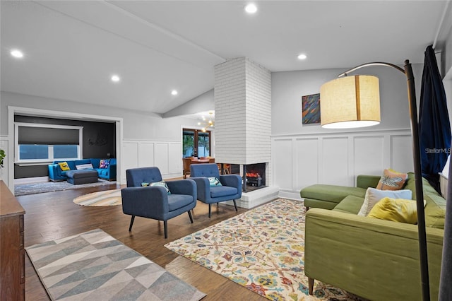 living room featuring lofted ceiling with beams, a multi sided fireplace, and wood-type flooring