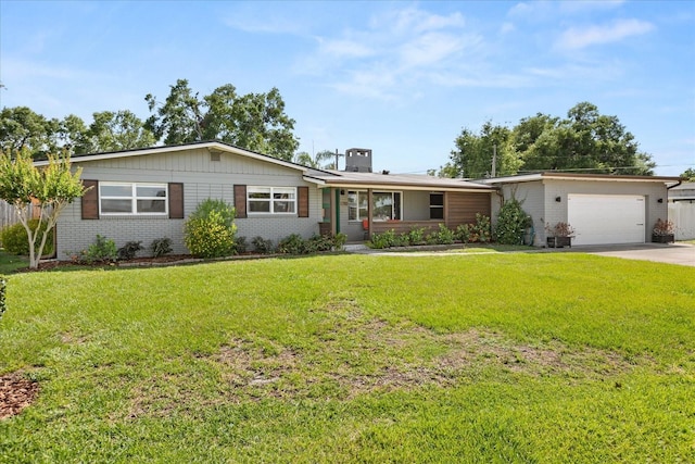 single story home featuring brick siding, a garage, driveway, a front yard, and a chimney