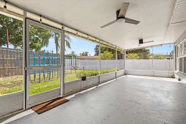 unfurnished sunroom with ceiling fan and healthy amount of natural light