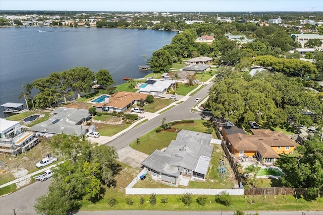 aerial view of property and surrounding area featuring a nearby body of water and nearby suburban area