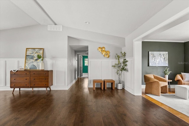 entryway with a decorative wall, wood finished floors, and a wainscoted wall