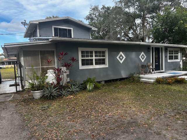 view of front of house with a sunroom