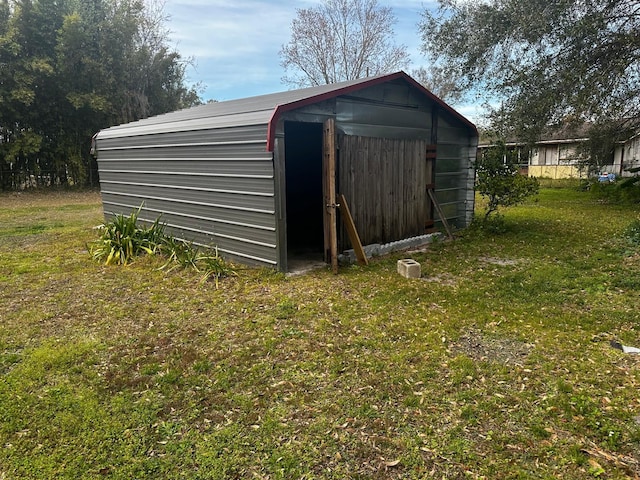 view of outbuilding featuring a yard