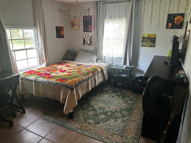 tiled bedroom featuring multiple windows