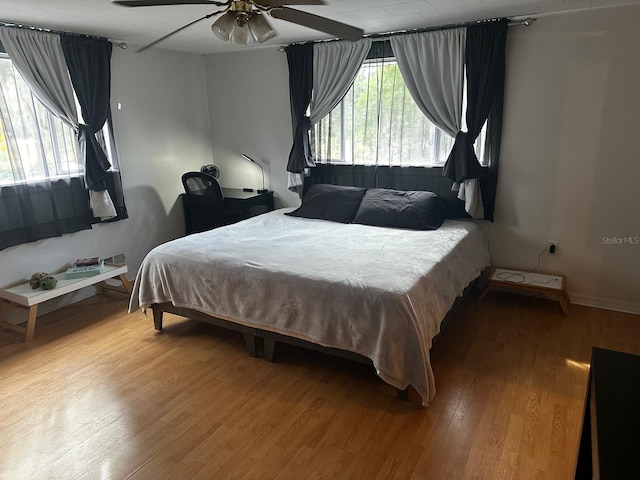 bedroom with ceiling fan and wood-type flooring