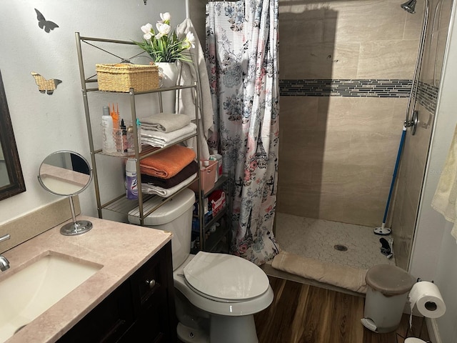 bathroom with walk in shower, vanity, wood-type flooring, and toilet