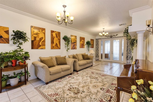 living room with a textured ceiling, an inviting chandelier, light tile patterned floors, and french doors