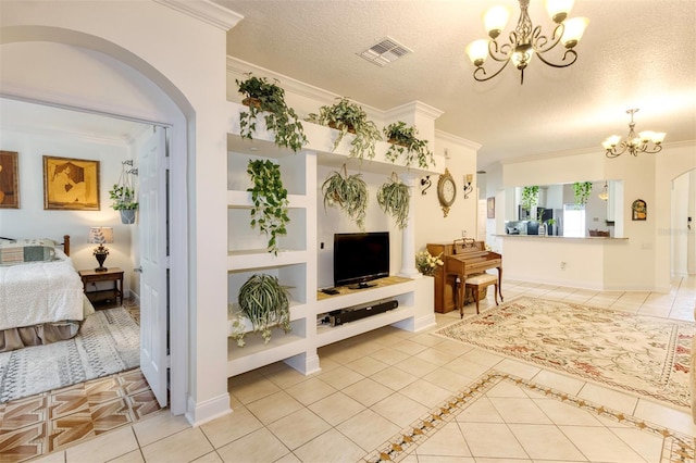 living room with crown molding, built in features, a textured ceiling, light tile patterned floors, and a chandelier