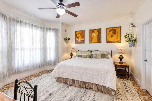 bedroom with ceiling fan, a textured ceiling, and crown molding