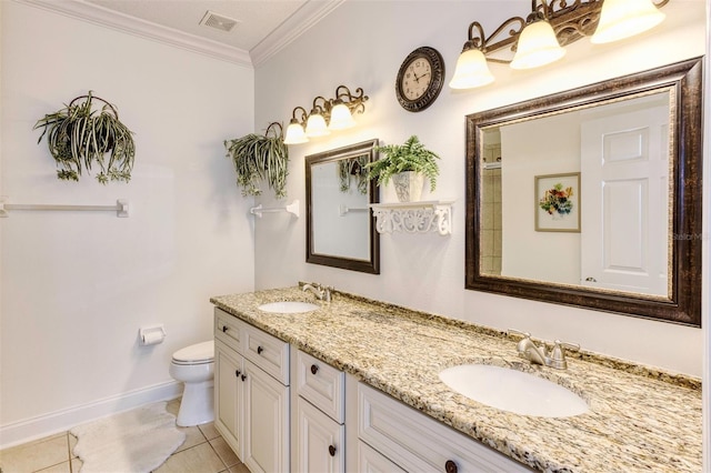 bathroom with toilet, vanity, tile patterned floors, and ornamental molding