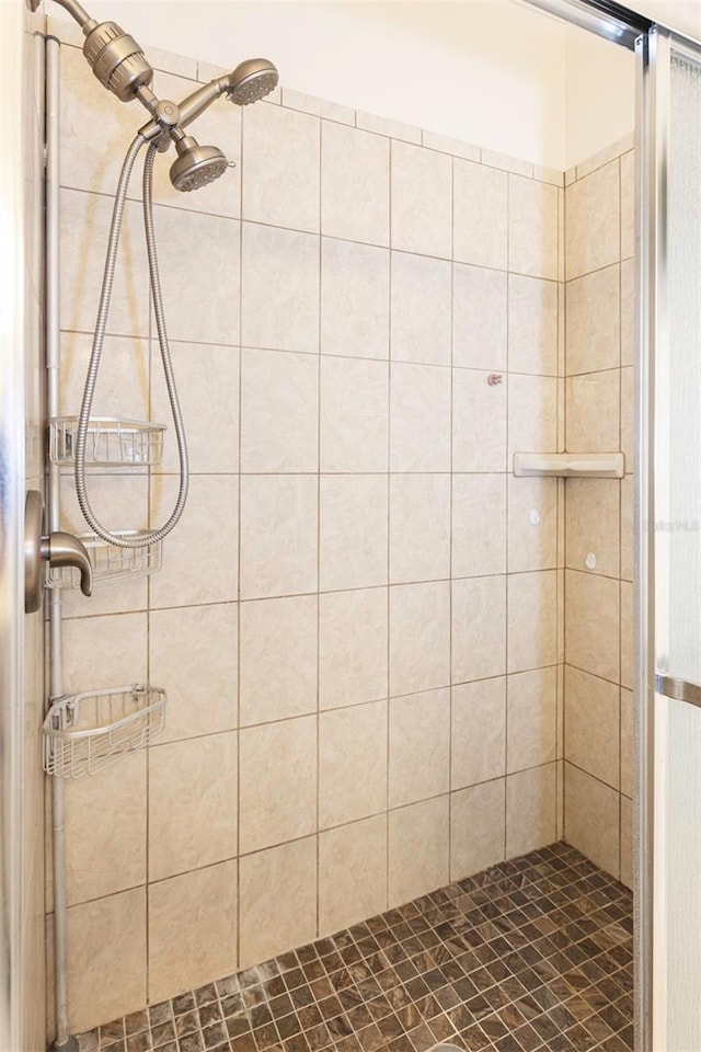 bathroom with a tile shower