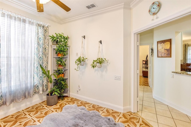 unfurnished room featuring ceiling fan, light tile patterned floors, and crown molding