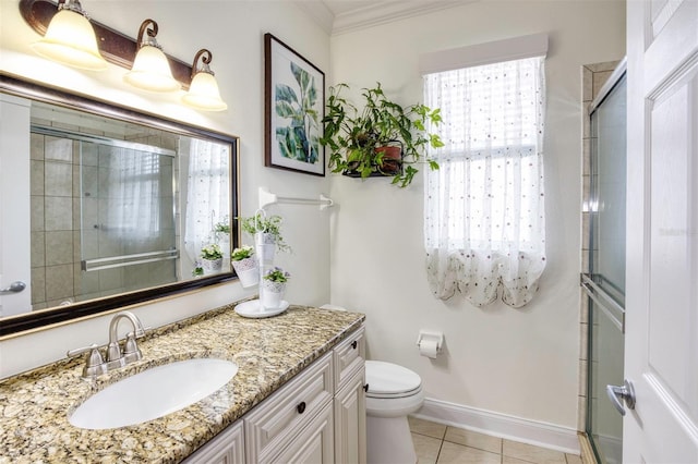 bathroom featuring toilet, vanity, tile patterned floors, crown molding, and a shower with shower door