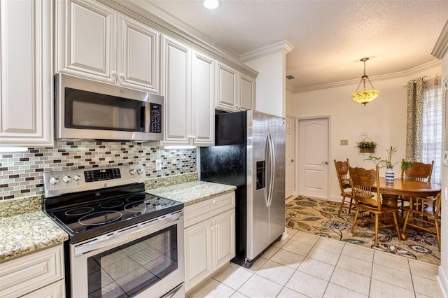 kitchen with tasteful backsplash, crown molding, hanging light fixtures, appliances with stainless steel finishes, and light tile patterned floors