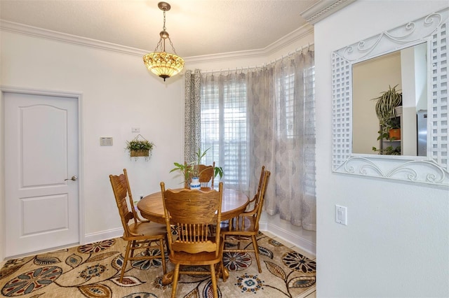 dining space with crown molding