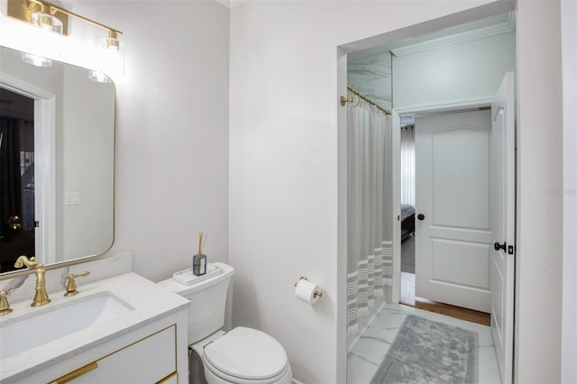 bathroom featuring toilet, vanity, and a shower with curtain